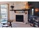 Close up of a stone fireplace with mantel decor and a sliding door leading to the balcony at 8555 Fairmount Dr # B202, Denver, CO 80247