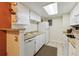 Functional kitchen features ample cabinet space and essential appliances at 8555 Fairmount Dr # B202, Denver, CO 80247