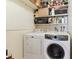 Functional laundry area with a washer, dryer, and shelving for organized storage solutions at 8555 Fairmount Dr # B202, Denver, CO 80247