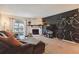 Comfortable living room with decor, a stone fireplace, and a sliding glass door at 8555 Fairmount Dr # B202, Denver, CO 80247