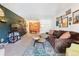 Cozy living room features a comfortable brown couch and dark accent wall at 8555 Fairmount Dr # B202, Denver, CO 80247