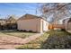 Backyard featuring a small lawn, brick paver patio, and a detached garage, ideal for outdoor living at 2470 Meade St, Denver, CO 80211