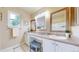 Well-lit bathroom with double sinks, vanity area, and stylish mirrors at 11301 Vernon Way, Parker, CO 80134