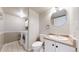 Bathroom with laundry area, featuring a toilet, sink with cabinet, and washer/dryer at 11301 Vernon Way, Parker, CO 80134