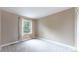 Bright bedroom featuring neutral carpet, and a large window with natural light at 11301 Vernon Way, Parker, CO 80134