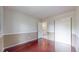 Bedroom with hardwood floors featuring a closet and a bathroom entry at 11301 Vernon Way, Parker, CO 80134