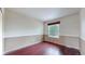 Cozy bedroom featuring hardwood floors, neutral paint, and natural light from a window at 11301 Vernon Way, Parker, CO 80134