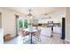 Open dining area with natural light, modern lighting, and a view of the backyard through sliding glass doors at 11301 Vernon Way, Parker, CO 80134
