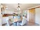 Charming dining area adjacent to the kitchen featuring modern lighting, a rustic barn door, and stylish decor at 11301 Vernon Way, Parker, CO 80134