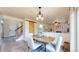 Cozy dining area with modern lighting, a rustic barn door accent, and an inviting view into the adjacent living room at 11301 Vernon Way, Parker, CO 80134
