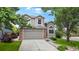 Charming two-story home with a well-manicured lawn, mature trees, and a spacious driveway leading to an attached garage at 11301 Vernon Way, Parker, CO 80134