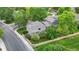 Aerial view of a well-maintained home with mature trees, lush landscaping, and a fenced-in yard at 11301 Vernon Way, Parker, CO 80134