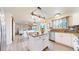 Well-lit kitchen featuring modern appliances, stylish backsplash, and a center island for food preparation and casual dining at 11301 Vernon Way, Parker, CO 80134