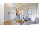 Spacious living area with soaring ceilings and natural light, complemented by modern decor and open staircase at 11301 Vernon Way, Parker, CO 80134
