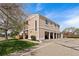 Tan townhouse featuring individual garages, well-kept landscaping and beautiful blue skies at 8798 Chase Dr # 4, Arvada, CO 80003