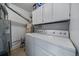 Functional laundry area with washer, dryer, storage cabinets and utilitarian features at 8798 Chase Dr # 4, Arvada, CO 80003