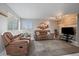 Comfortable living room with brown leather couches, wood accent wall, and neutral decor at 8798 Chase Dr # 4, Arvada, CO 80003