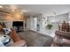 Spacious living room featuring a wooden accent wall, plush rug, and lots of natural light at 8798 Chase Dr # 4, Arvada, CO 80003