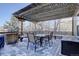 Cozy deck with pergola, seating area, and snow covered scenery at 3925 Broadview Pl, Castle Rock, CO 80109