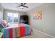 Bright bedroom with multicolored bedding and ceiling fan at 3925 Broadview Pl, Castle Rock, CO 80109