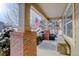 Covered porch with brick columns, American flag, and bench at 3925 Broadview Pl, Castle Rock, CO 80109