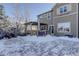 Two-story house with backyard patio and snowy landscaping at 3925 Broadview Pl, Castle Rock, CO 80109