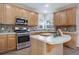 Kitchen boasts stainless steel appliances and ample wood cabinetry at 3925 Broadview Pl, Castle Rock, CO 80109