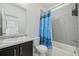 Clean, bright bathroom with a gray tiled shower, vanity sink with granite countertop, and neutral decor at 5278 Warrior St, Frederick, CO 80504
