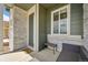 Inviting front porch with stone accents, seating, and a stylish door, perfect for relaxing and welcoming guests at 5278 Warrior St, Frederick, CO 80504