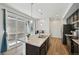 Contemporary kitchen featuring a center island, stainless steel appliances, and sliding glass doors to the patio at 5278 Warrior St, Frederick, CO 80504