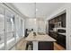Modern kitchen with stainless appliances, dark cabinetry, island with a granite countertop, and sliding glass doors to the patio at 5278 Warrior St, Frederick, CO 80504