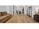 Open-concept living space with hardwood floors, modern lighting, and seamless transition to the kitchen area at 5278 Warrior St, Frederick, CO 80504