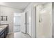 Double vanity bathroom with a large shower and tile floors at 6104 Black Mesa Rd, Frederick, CO 80516