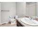 Bathroom with toilet, sink, and dark brown vanity at 6104 Black Mesa Rd, Frederick, CO 80516