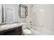 Clean bathroom with a shower/tub combo and dark vanity at 6104 Black Mesa Rd, Frederick, CO 80516