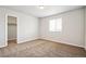 Bright bedroom with neutral walls, carpet, and a spacious closet at 6104 Black Mesa Rd, Frederick, CO 80516