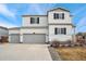 Two-story house with gray trim, two-car garage, and landscaping at 6104 Black Mesa Rd, Frederick, CO 80516