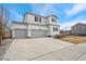 Two-story house with gray trim, three-car garage, and landscaping at 6104 Black Mesa Rd, Frederick, CO 80516