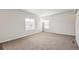 Bright living room with carpeted floor and neutral walls at 6104 Black Mesa Rd, Frederick, CO 80516