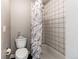 Simple bathroom featuring a toilet and shower/tub combination with a white tile surround at 2280 S Oswego Way # 303, Aurora, CO 80014