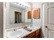 The bathroom features a double sink vanity, a large mirror, and unique shuttered storage at 2280 S Oswego Way # 303, Aurora, CO 80014
