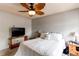 This comfortable bedroom includes a TV, side tables, and a cozy bed with decorative pillows at 2280 S Oswego Way # 303, Aurora, CO 80014