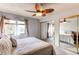 Bright bedroom featuring mirror closet doors and windows with charming curtains for soft, natural light at 2280 S Oswego Way # 303, Aurora, CO 80014