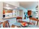 Dining area with breakfast bar overlooking kitchen, fireplace, and comfy living room at 2280 S Oswego Way # 303, Aurora, CO 80014
