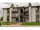 Attractive multi-story condo building with private balconies and well-maintained landscaping at 2280 S Oswego Way # 303, Aurora, CO 80014
