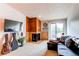 Comfortable living room featuring a fireplace, balcony access, and ample natural light at 2280 S Oswego Way # 303, Aurora, CO 80014