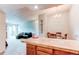 Open living space with kitchen island, adjacent dining area, and sliding glass doors to balcony at 2280 S Oswego Way # 303, Aurora, CO 80014