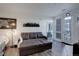 Modern living room with a gray pullout couch, decorative light fixture, and art prints at 8475 E 36Th Ave # 331, Denver, CO 80238