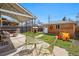 Large backyard with a patio, playhouse, storage shed and green chairs, ideal for Gathering fun at 3415 N Vine St, Denver, CO 80205
