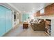 Spacious basement living area with storage, exposed brick accent wall, and cozy seating at 3415 N Vine St, Denver, CO 80205